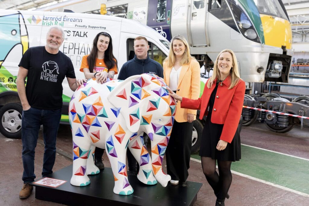 larnród Eireann team with a colorful elephant statue for inclusive train journeys.