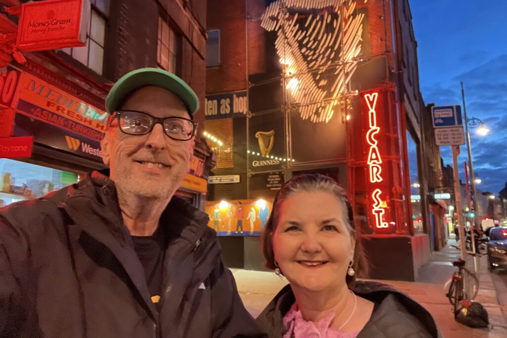 Couple smiling outside Vicar Street in Dublin at night